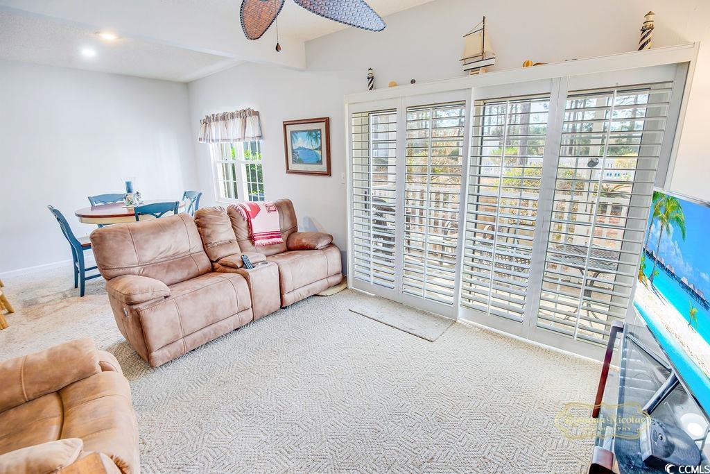 2203 Sweetwater Boulevard, Unit 2203 Murrells Inlet, SC 29576 - Photo 14 of 23 Carpeted living room featuring a ceiling fan and beamed ceiling