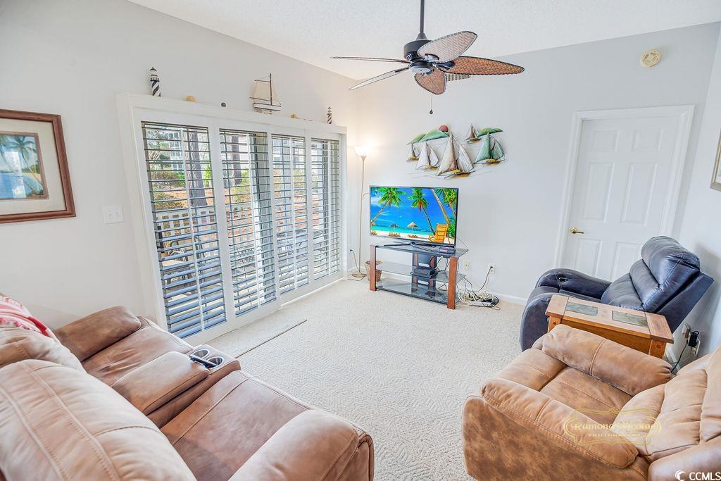 2203 Sweetwater Boulevard, Unit 2203 Murrells Inlet, SC 29576 - Photo 15 of 23 Carpeted living room with a ceiling fan, a textured ceiling, and baseboards