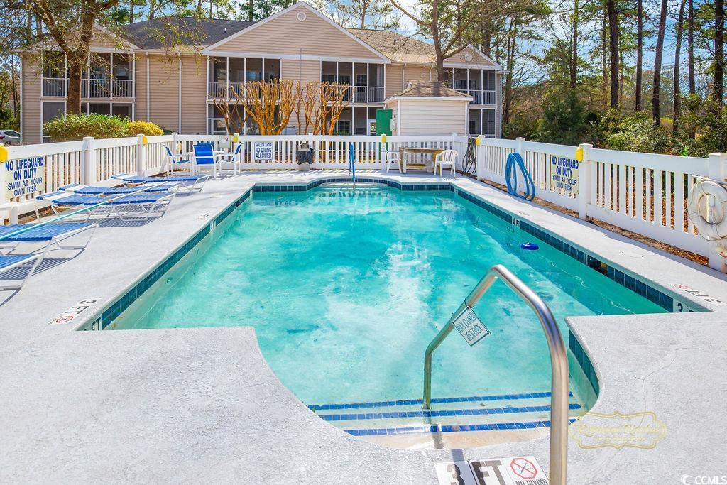 2203 Sweetwater Boulevard, Unit 2203 Murrells Inlet, SC 29576 - Photo 18 of 23 Community pool with a sunroom