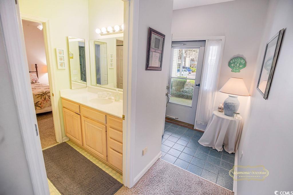 2203 Sweetwater Boulevard, Unit 2203 Murrells Inlet, SC 29576 - Photo 2 of 23 Bathroom featuring tile patterned floors, ensuite bath, baseboards, and vanity