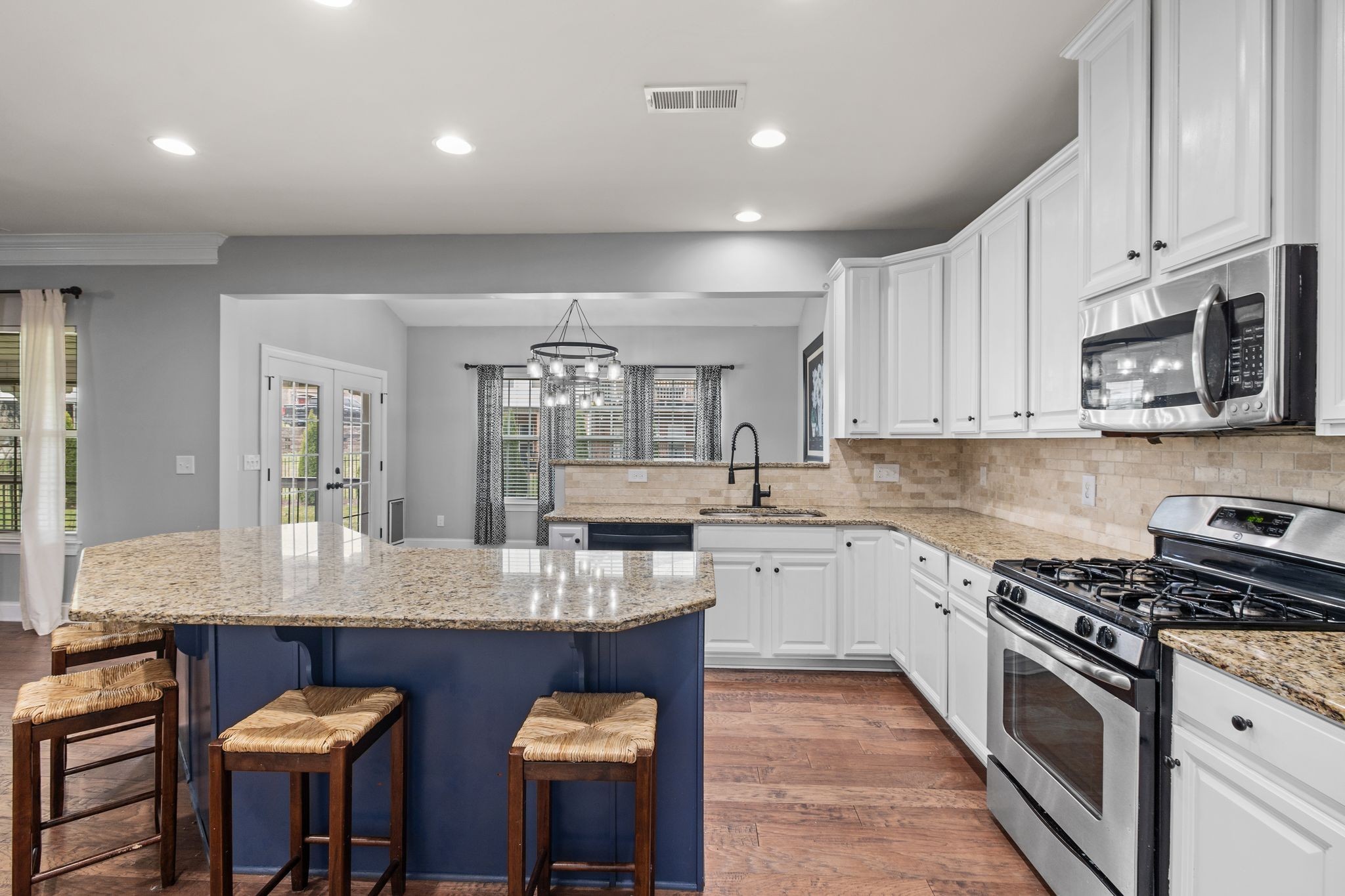 1931 Portview Drive Spring Hill, TN 37174 - Photo 23 of 51 a large kitchen with granite countertop a stove top oven a sink a counter space and cabinets