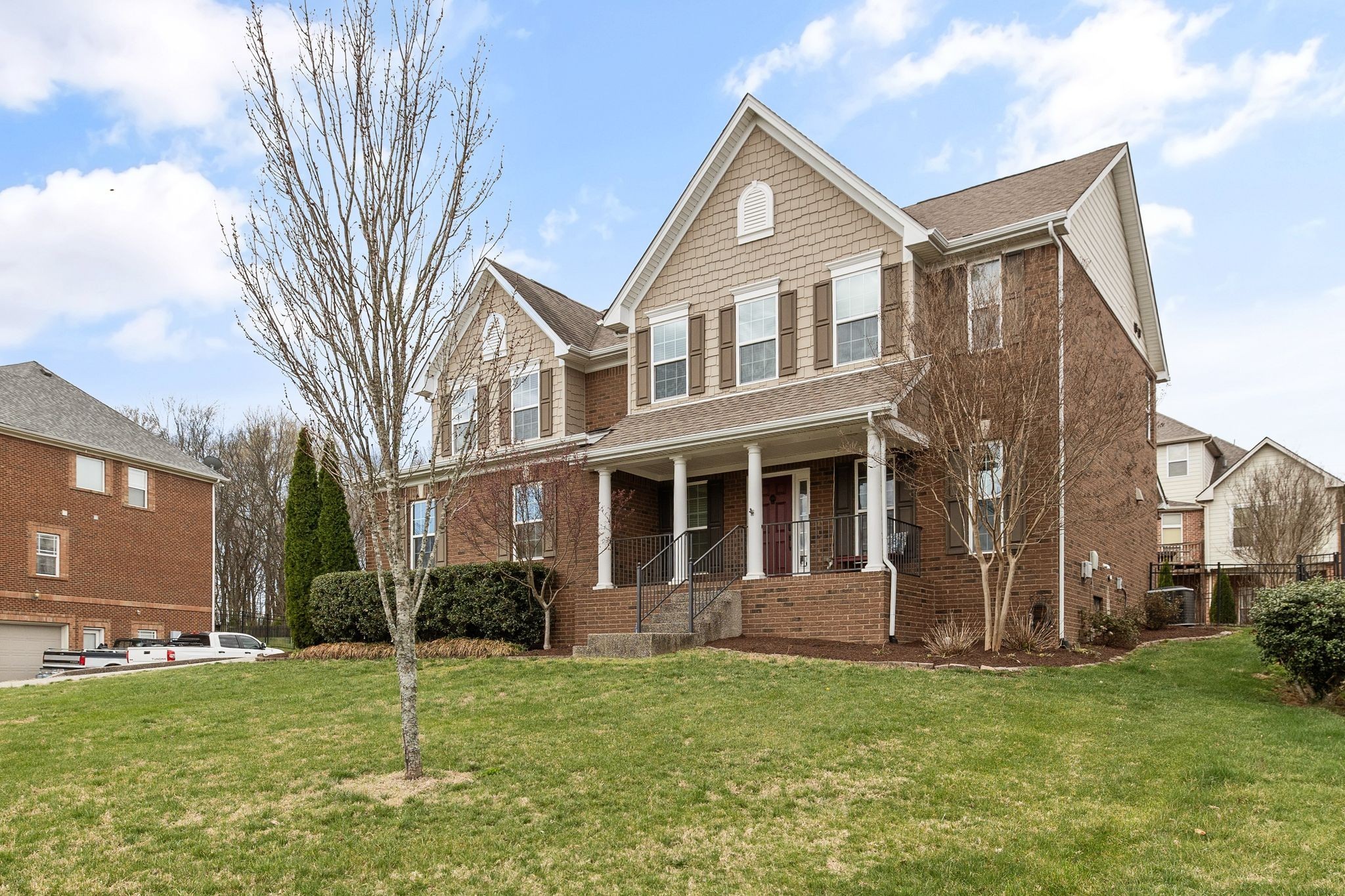 1931 Portview Drive Spring Hill, TN 37174 - Photo 10 of 51 a view of a yard in front of a brick house with a large tree