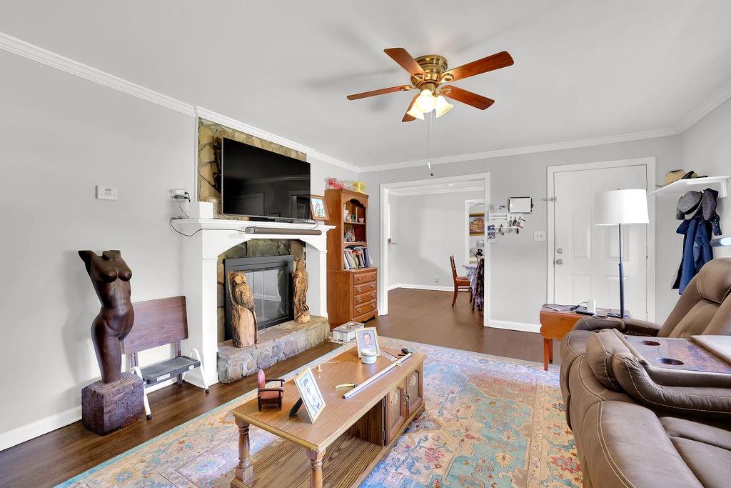 7618 Vaughn Road Woodstock, GA 30188 - Photo 13 of 44 a living room with furniture a flat screen tv and a fireplace