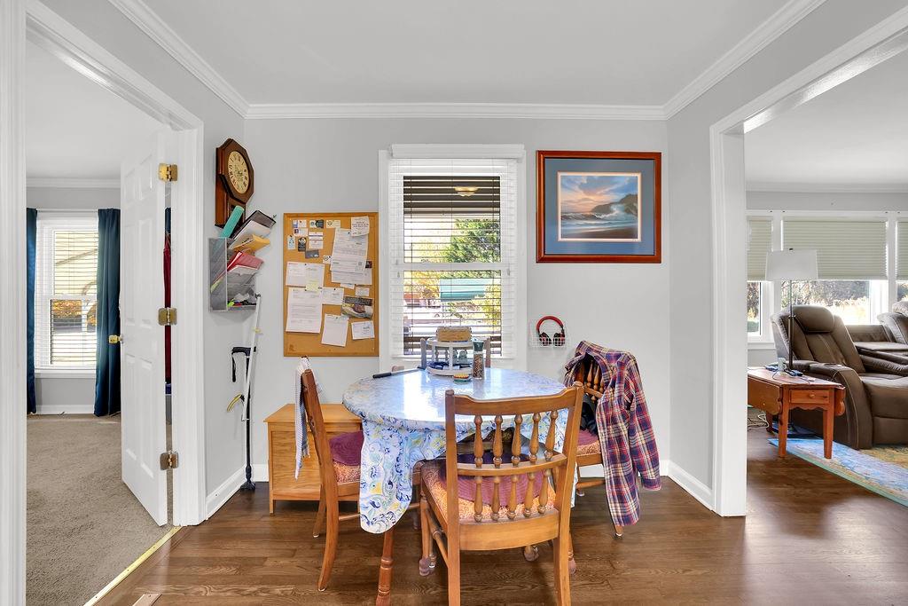 7618 Vaughn Road Woodstock, GA 30188 - Photo 15 of 44 a dining room with furniture and wooden floor