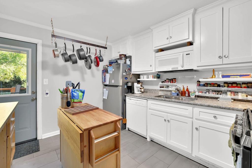7618 Vaughn Road Woodstock, GA 30188 - Photo 17 of 44 a kitchen with white cabinets and white appliances