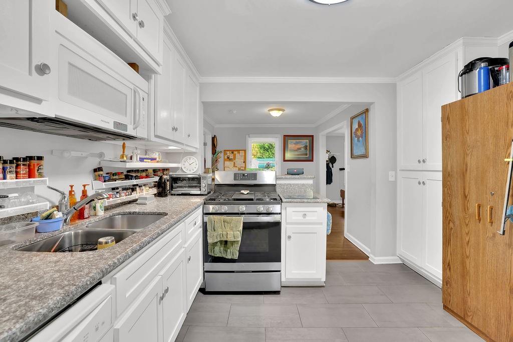 7618 Vaughn Road Woodstock, GA 30188 - Photo 19 of 44 a kitchen with stainless steel appliances granite countertop a sink stove and refrigerator