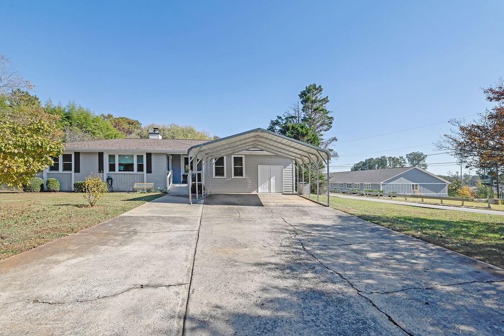 7618 Vaughn Road Woodstock, GA 30188 - Photo 2 of 44 a front view of a house with a yard