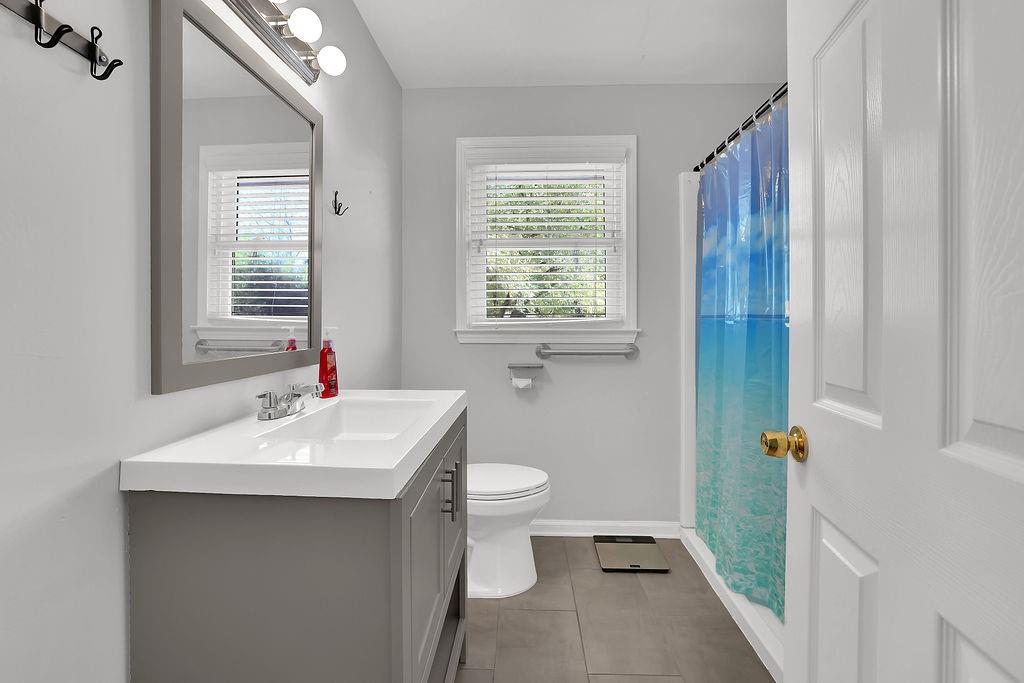 7618 Vaughn Road Woodstock, GA 30188 - Photo 23 of 44 a bathroom with a sink toilet and window