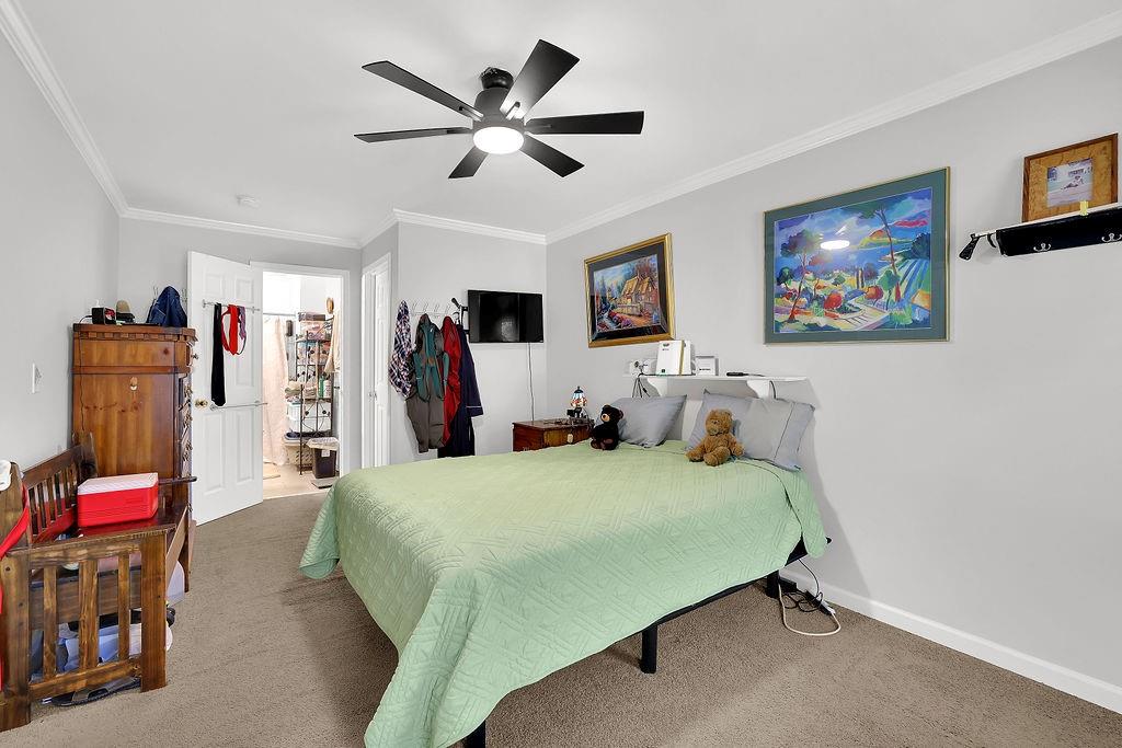 7618 Vaughn Road Woodstock, GA 30188 - Photo 27 of 44 a bedroom with a bed and a chandelier