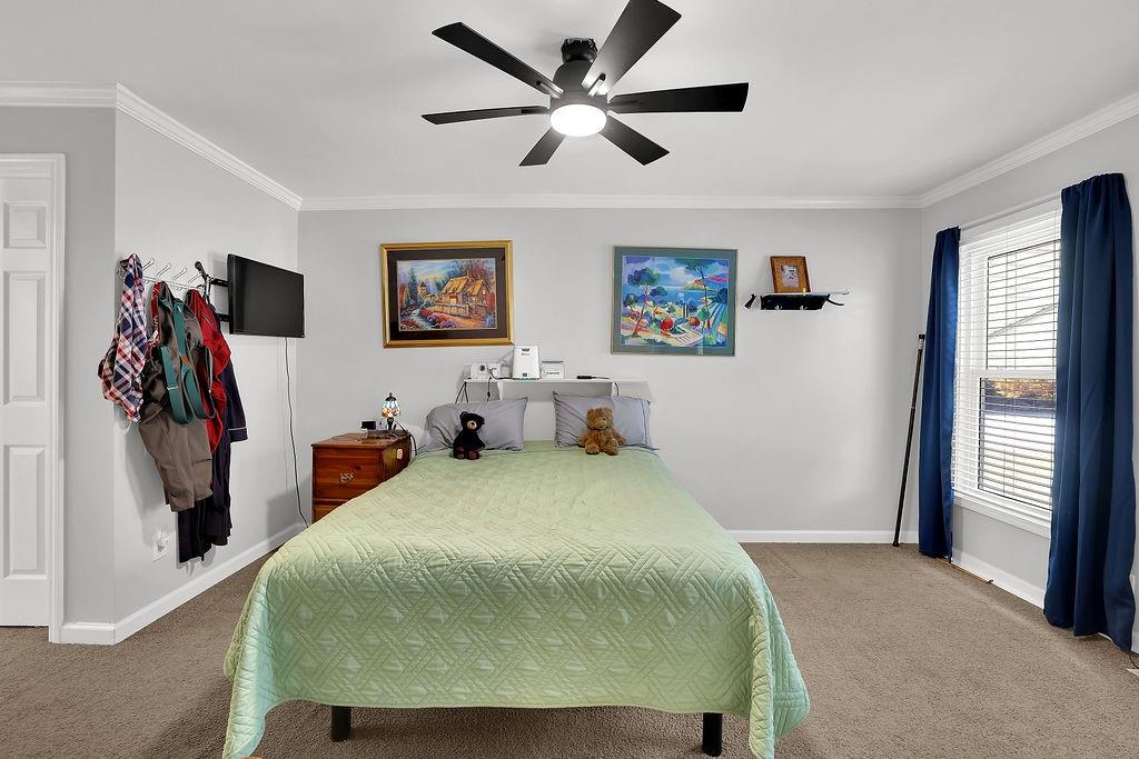 7618 Vaughn Road Woodstock, GA 30188 - Photo 28 of 44 a bedroom with a bed and a walk in closet