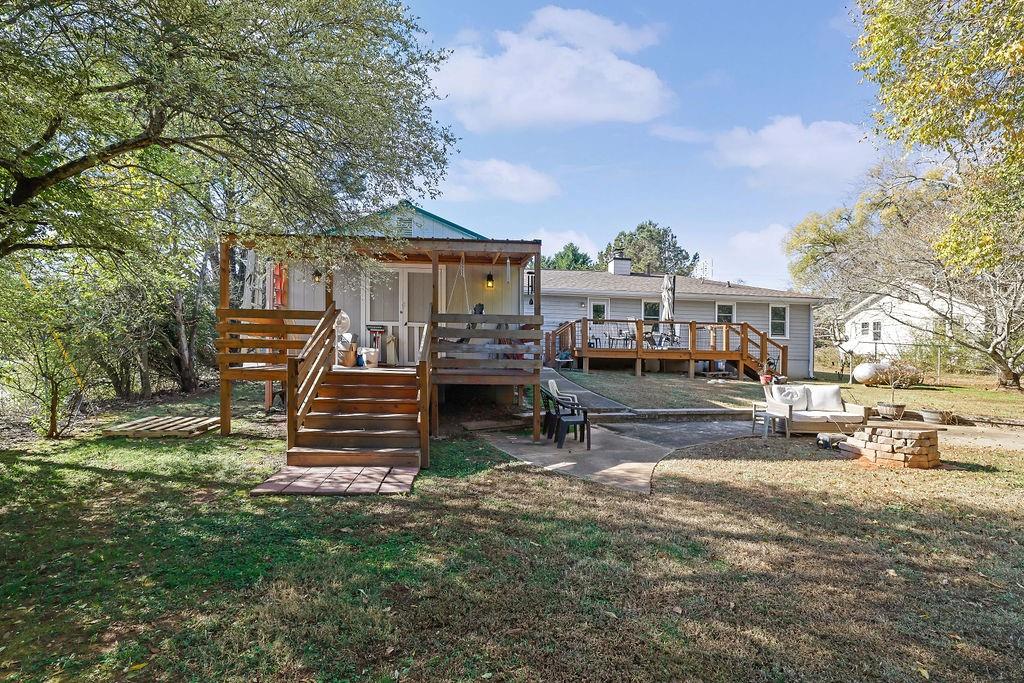 7618 Vaughn Road Woodstock, GA 30188 - Photo 33 of 44 a view of a house with a yard chairs and table