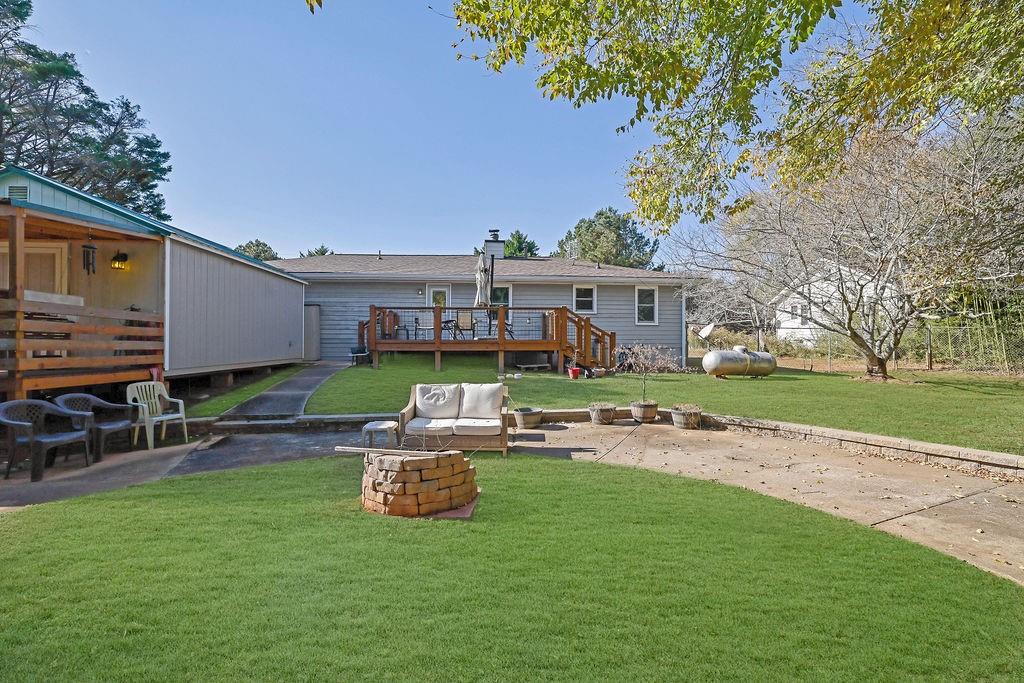 7618 Vaughn Road Woodstock, GA 30188 - Photo 36 of 44 a view of a house with backyard porch and sitting area