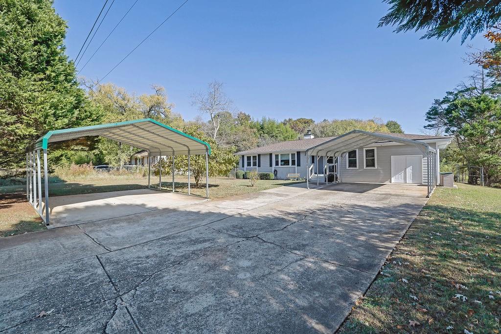 7618 Vaughn Road Woodstock, GA 30188 - Photo 4 of 44 a front view of a house with a yard
