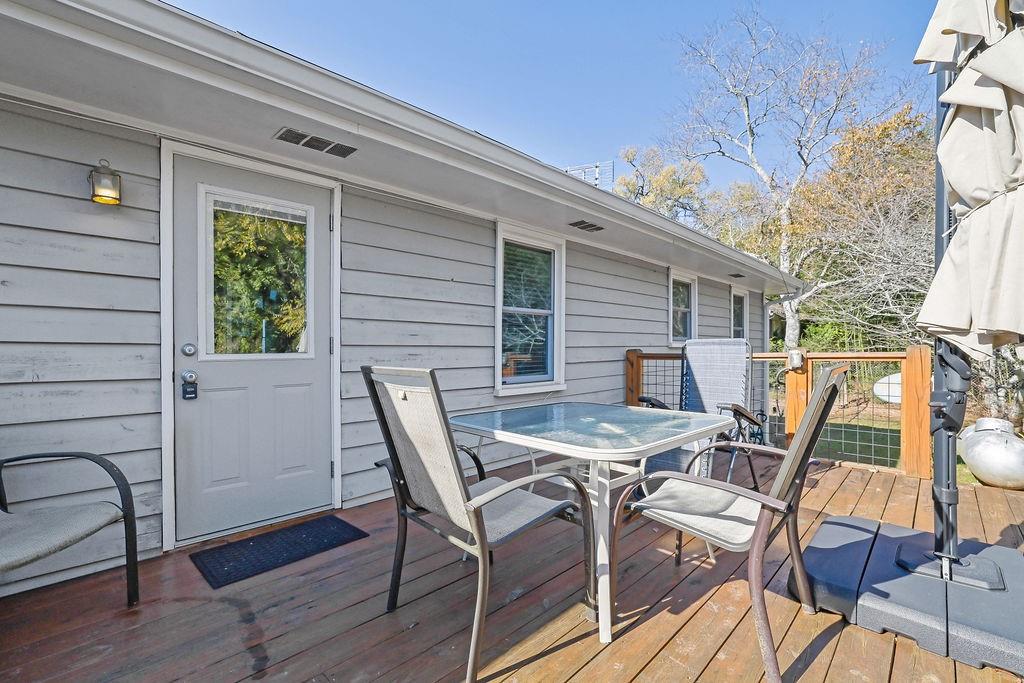 7618 Vaughn Road Woodstock, GA 30188 - Photo 41 of 44 a view of a patio with table and chairs with wooden floor and fence
