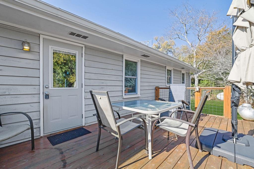 7618 Vaughn Road Woodstock, GA 30188 - Photo 42 of 44 a view of a patio with table and chairs with wooden floor and fence