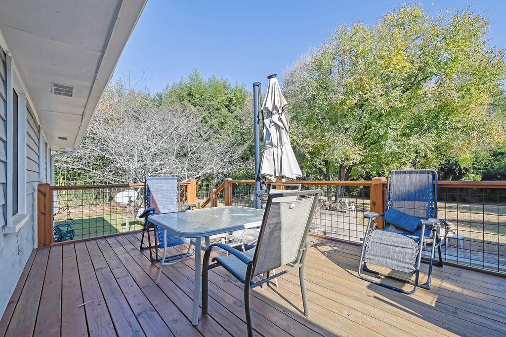 7618 Vaughn Road Woodstock, GA 30188 - Photo 43 of 44 a view of deck with table and chairs and wooden floor