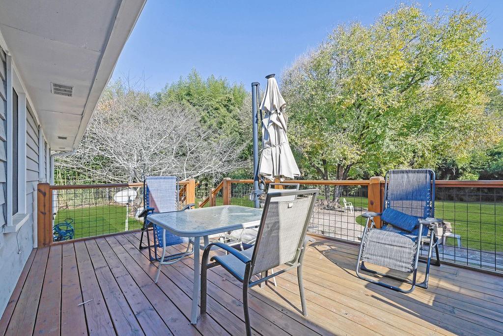 7618 Vaughn Road Woodstock, GA 30188 - Photo 44 of 44 a view of deck with table and chairs a barbeque with wooden floor and fence