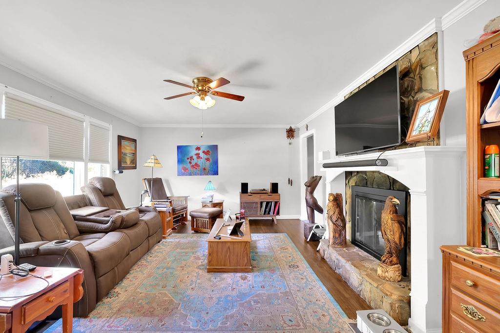 7618 Vaughn Road Woodstock, GA 30188 - Photo 9 of 44 a living room with furniture a flat screen tv and a fireplace
