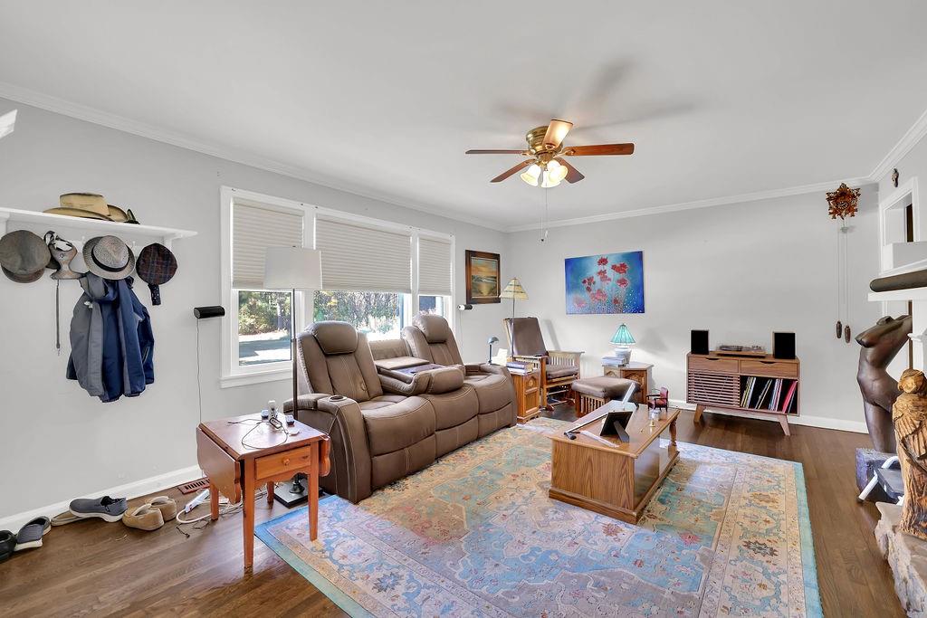 7618 Vaughn Road Woodstock, GA 30188 - Photo 10 of 44 a living room with furniture a rug and a flat screen tv