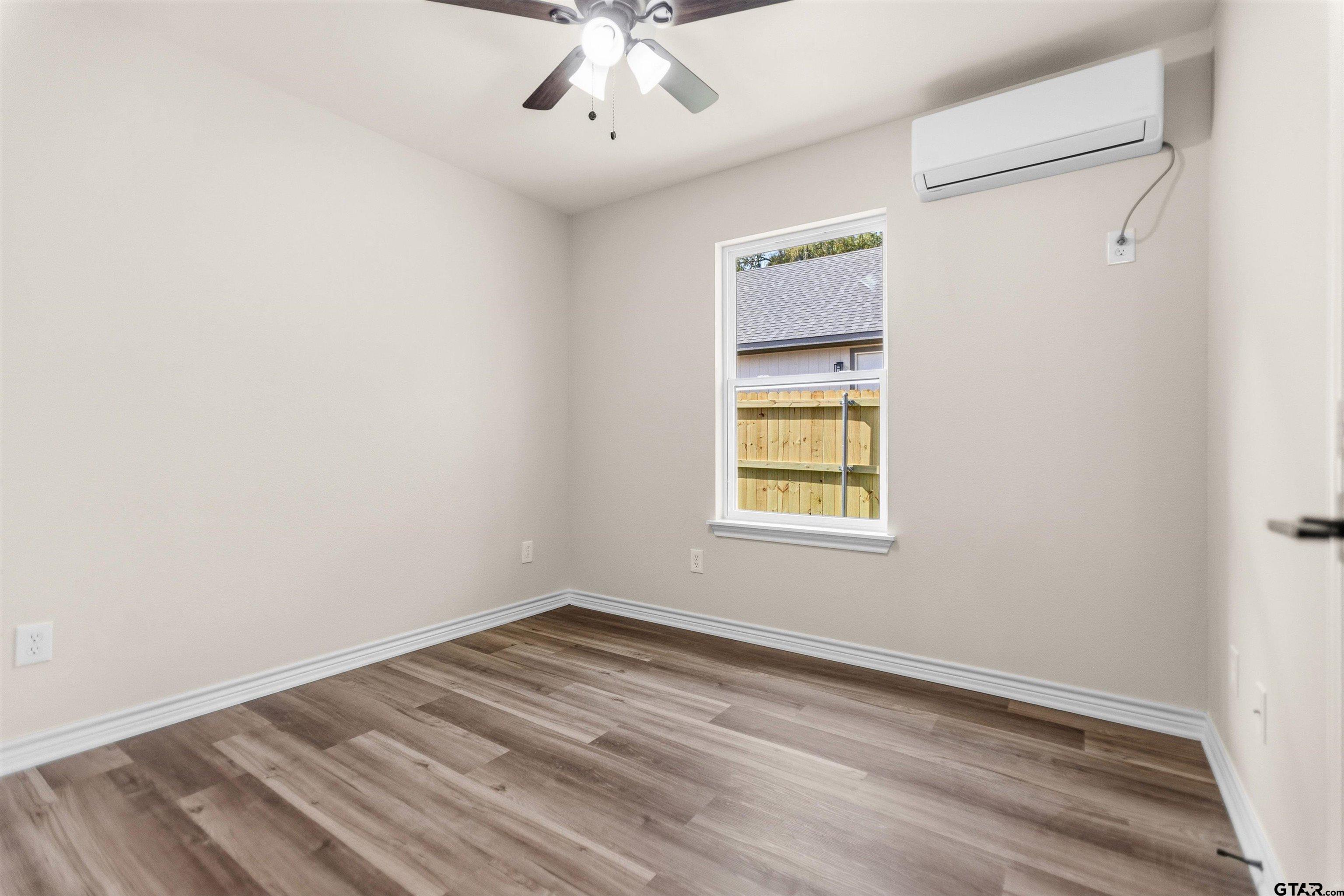 22463 Trailwood Road Flint, TX 75762 - Photo 9 of 17 an empty room with a window and ceiling fan