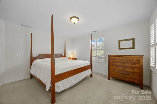 a bed room with a bed and a window