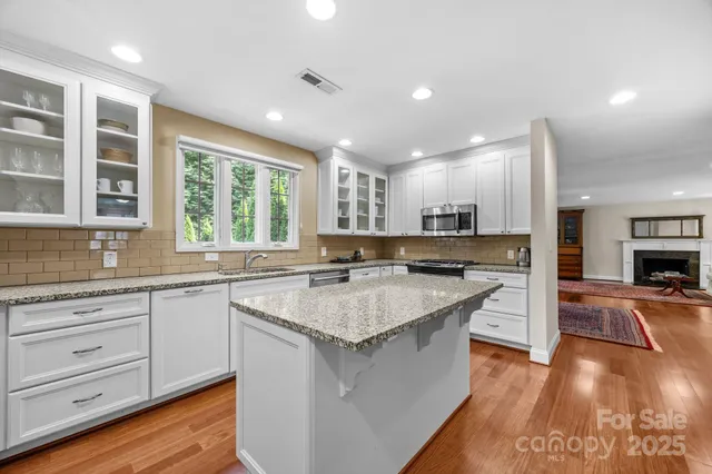 a kitchen with counter top space sink and center island