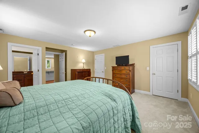 a bedroom with a bed and a television