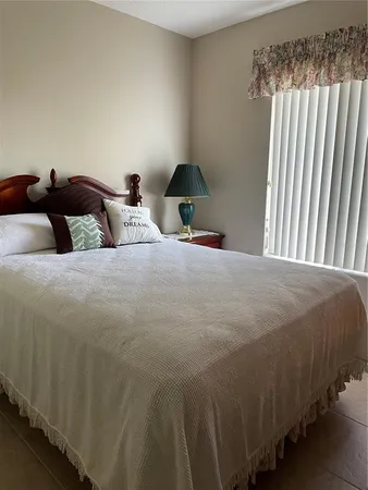 a bedroom with a bed and a lamp