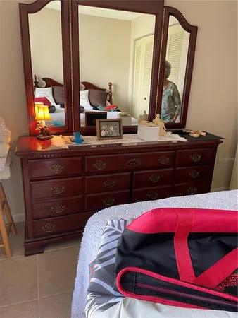 a bedroom with a bed and a mirror