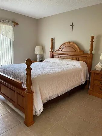 a bedroom with bed and a window