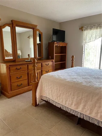 a bedroom with a bed and a television