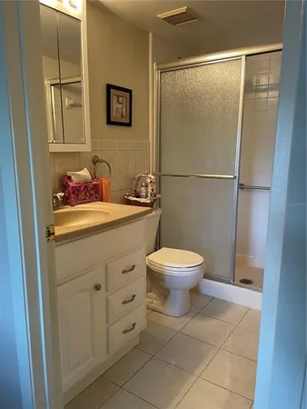 a bathroom with a toilet sink and shower
