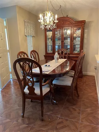 a view of a dining room with furniture and chandelier