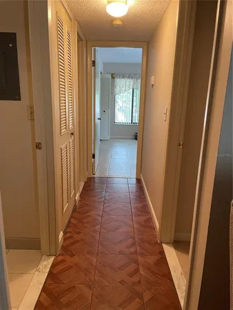 a view of a hallway with wooden floor and staircase