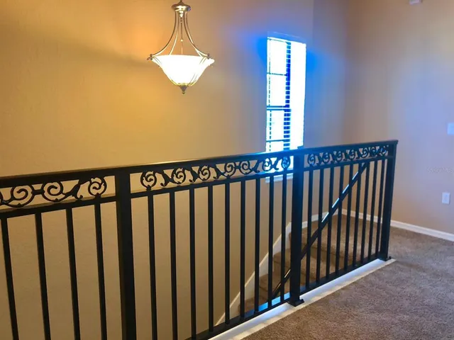 an empty room with a ceiling fan and a window