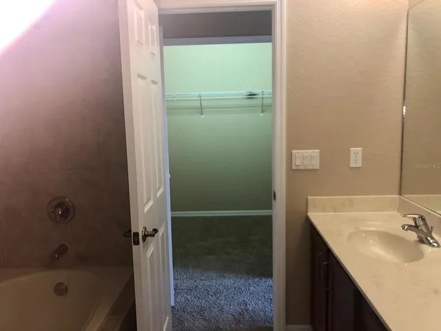 a bathroom with a glass shower door