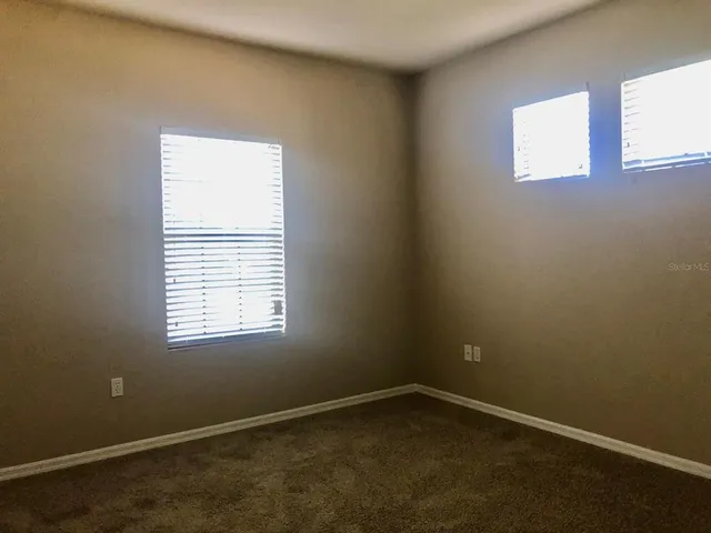 a view of a house with a yard and tree s