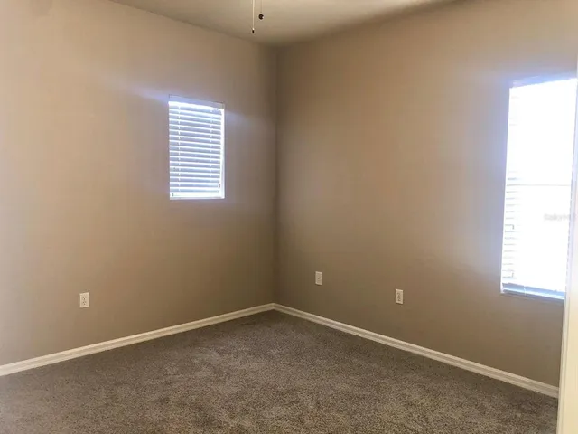 a kitchen with granite countertop a sink and a stove top oven with wooden floor
