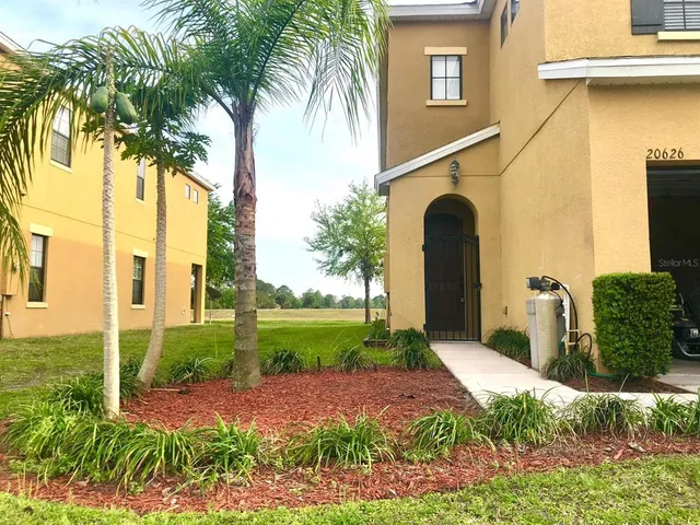 a kitchen with stainless steel appliances granite countertop wooden cabinets a refrigerator and a sink