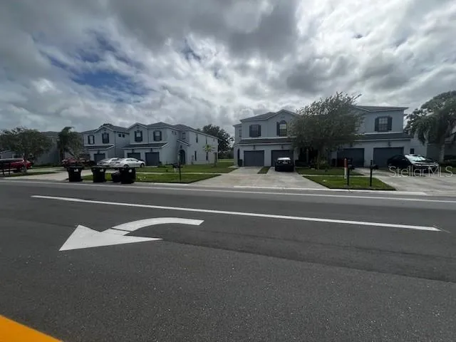 a kitchen with granite countertop stainless steel appliances a sink stove and refrigerator