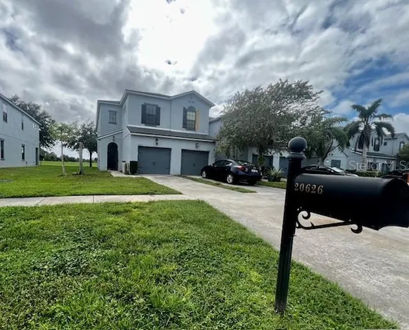 a kitchen with granite countertop a refrigerator and a stove top oven