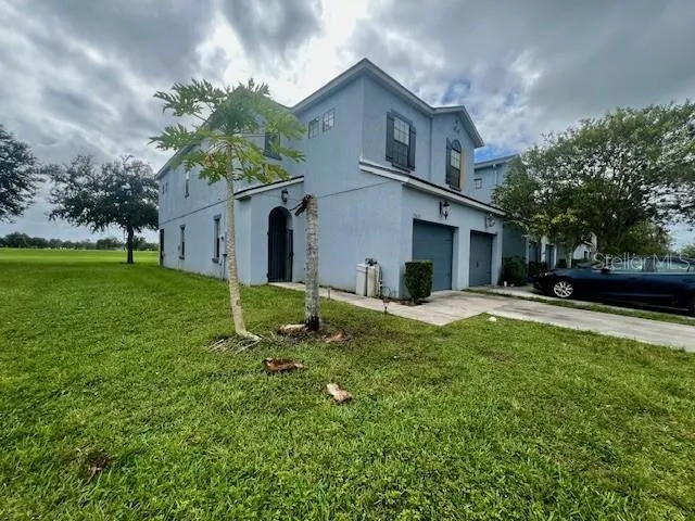 a kitchen with granite countertop wooden cabinets and a refrigerator