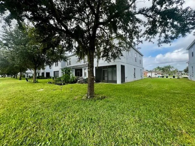 an empty room with a chandelier fan and window