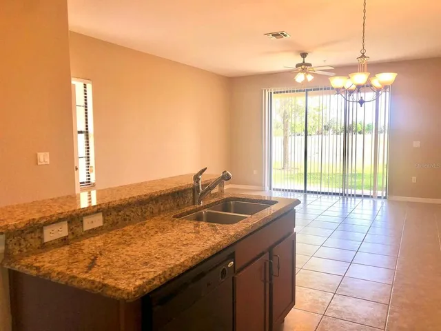 a view of a room with wooden floor and windows