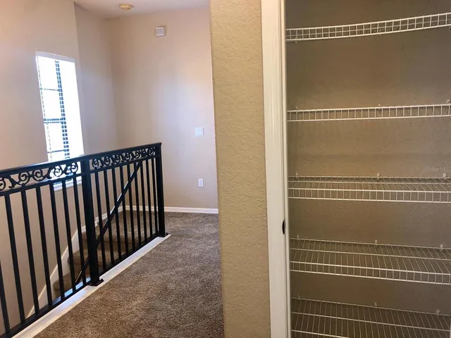 a view of kitchen with stainless steel appliances kitchen island granite countertop a refrigerator a stove top oven with a sink and dishwasher