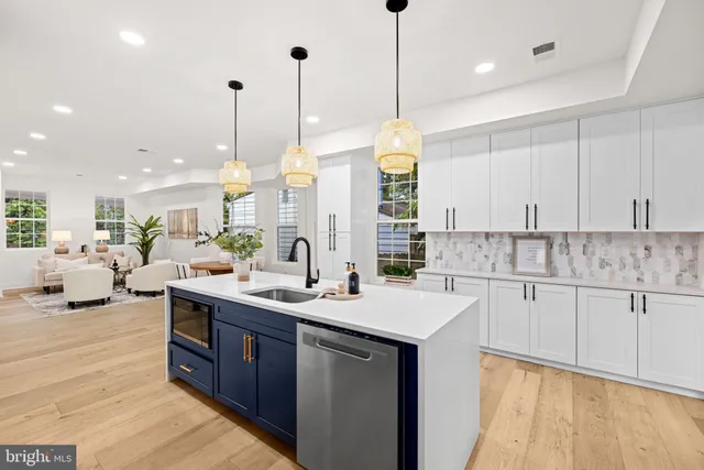 a kitchen with kitchen island granite countertop a sink counter top space and living room view