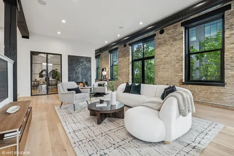 a living room with furniture and large windows