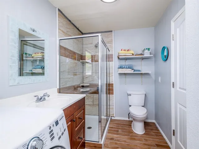 a spacious bathroom with a sink a toilet and shower