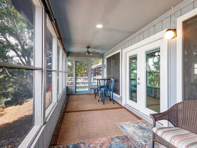 a porch with chairs and glass door