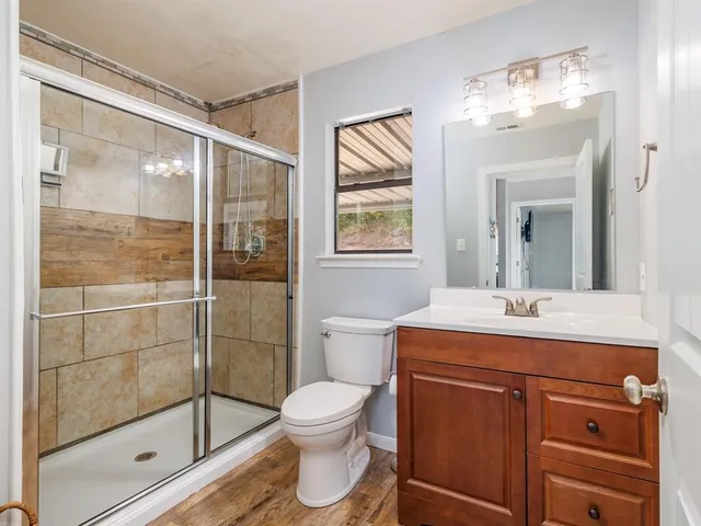 a bathroom with a sink toilet and shower